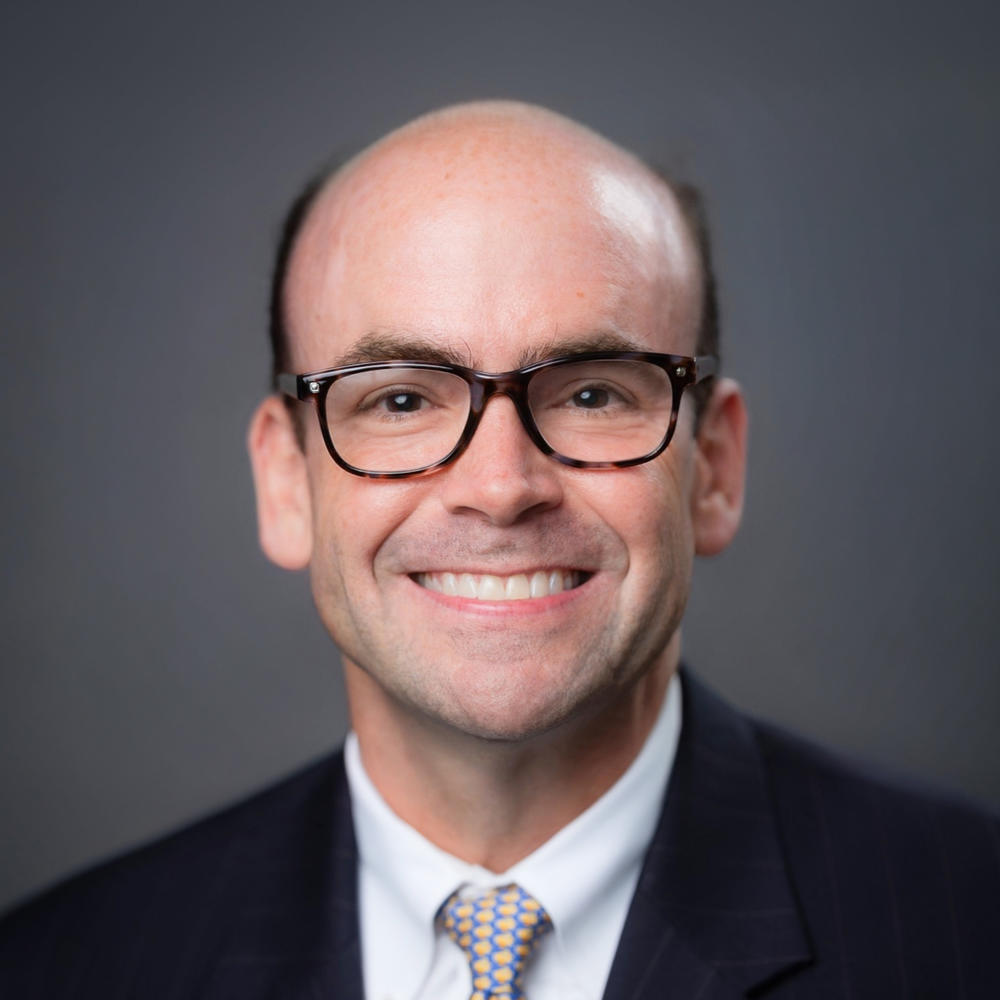 Photo of Board Member David Glass wearing glasses